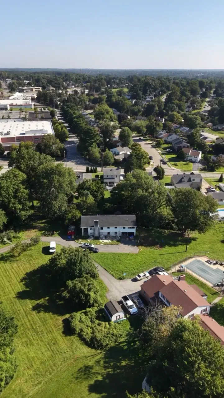 Wide drone view showing the large lot among the surrounding Springfield neighborhood.