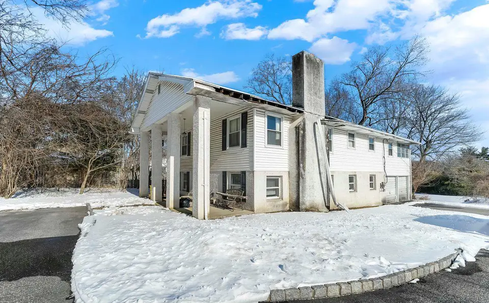 Before: the front of the house in winter 2026, before the renovation.