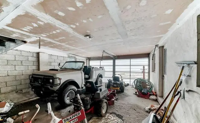 Before: the old garage with unfinished walls and a worn concrete floor.