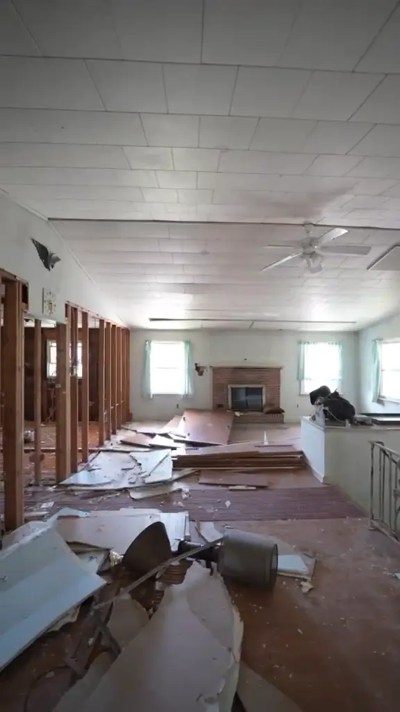 The living room mid-demolition, with flooring and debris pulled up.