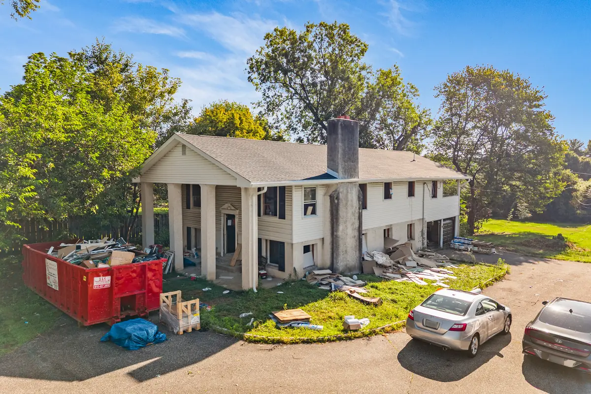 The front of the house during the renovation, under a clear sky.