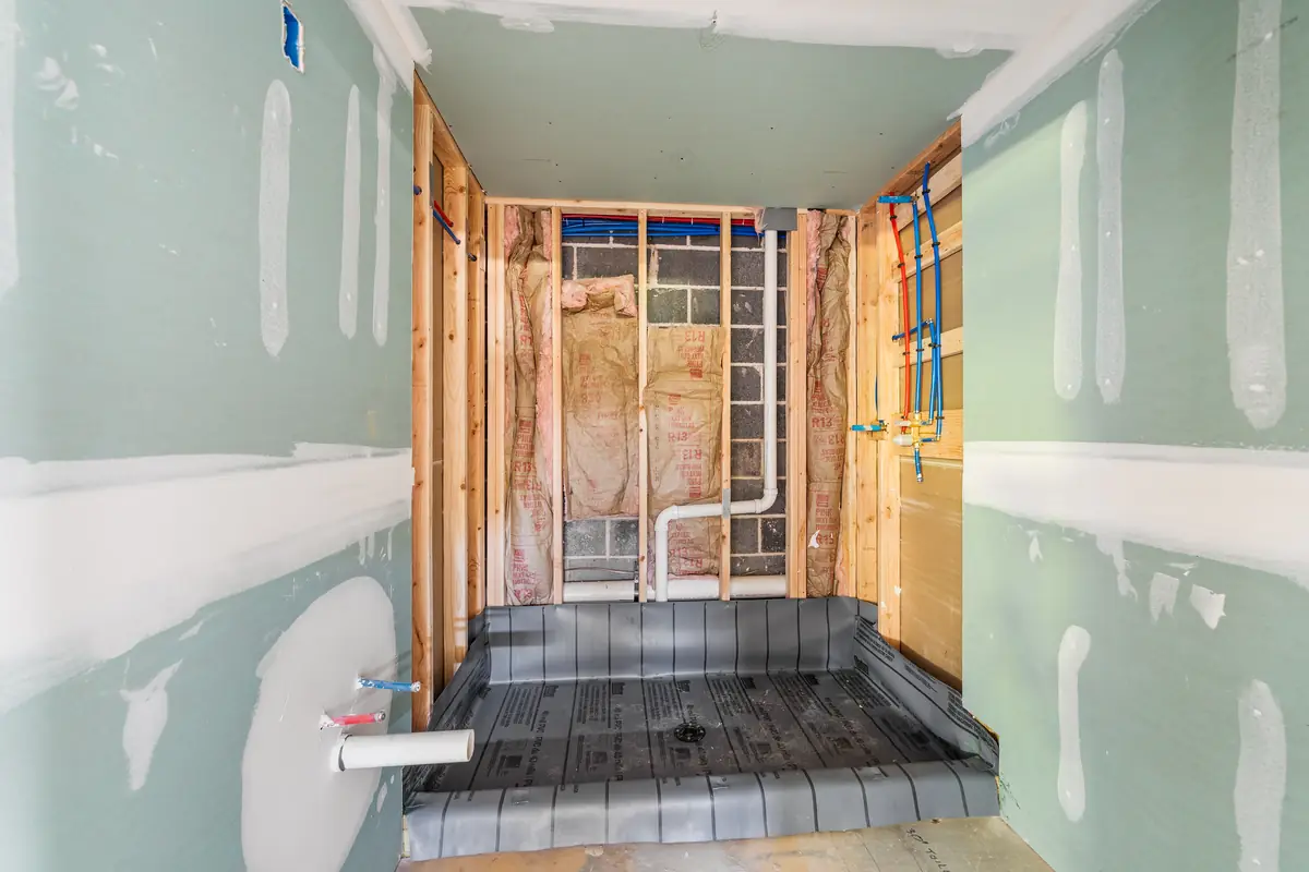 A shower with moisture-resistant board and a tiled pan, ready for wall tile.
